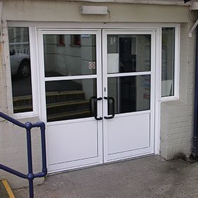 White aluminium double doors with windows either side